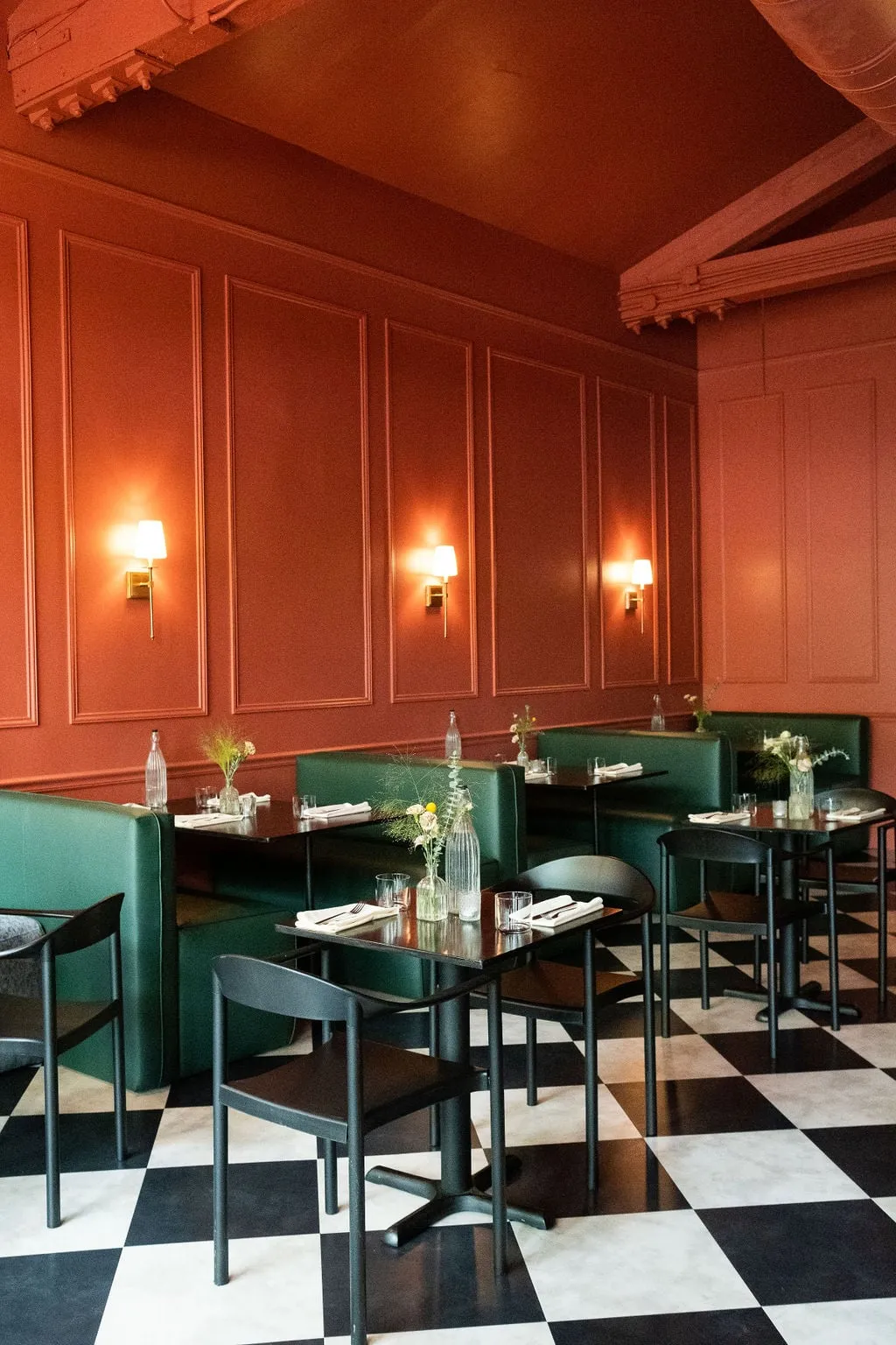 Portland restaurant dining room with green banquettes, designed by Noema