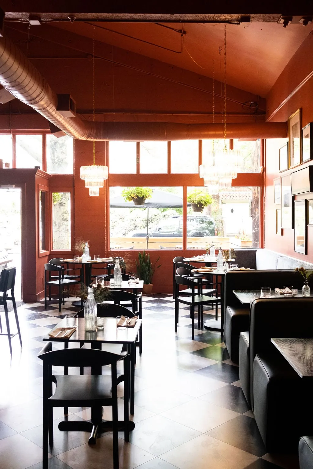 Full restaurant dining room designed by Noema, looking toward the front windows